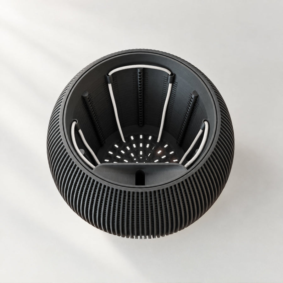 Top view of a Luxe planter showing the perforated inner pot and white wicks.