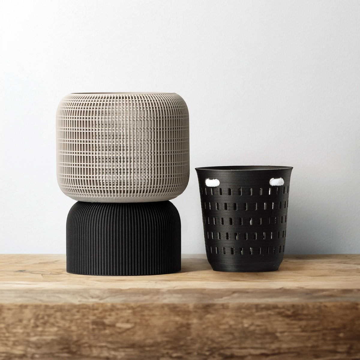Gray VerdiPot Cocoon self-watering planter on a black base, beside its removable air-pruning inner pot.