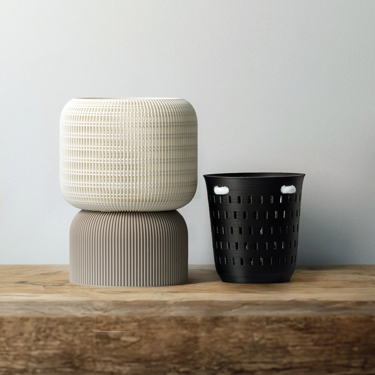 White VerdiPot Cocoon self-watering planter on a gray base, beside its removable black air-pruning inner pot.