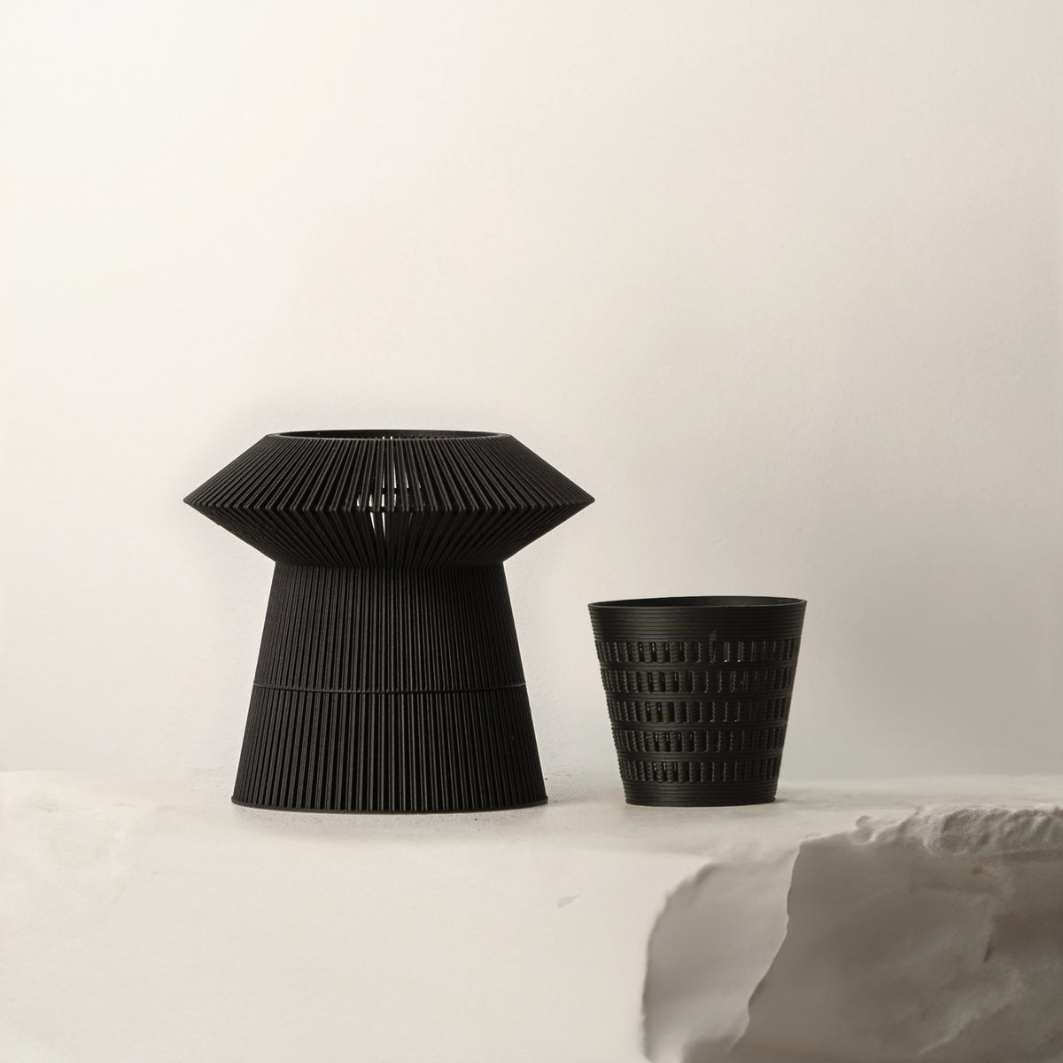 Black VerdiPot Revolve self-watering planter beside its removable air-pruning inner pot.