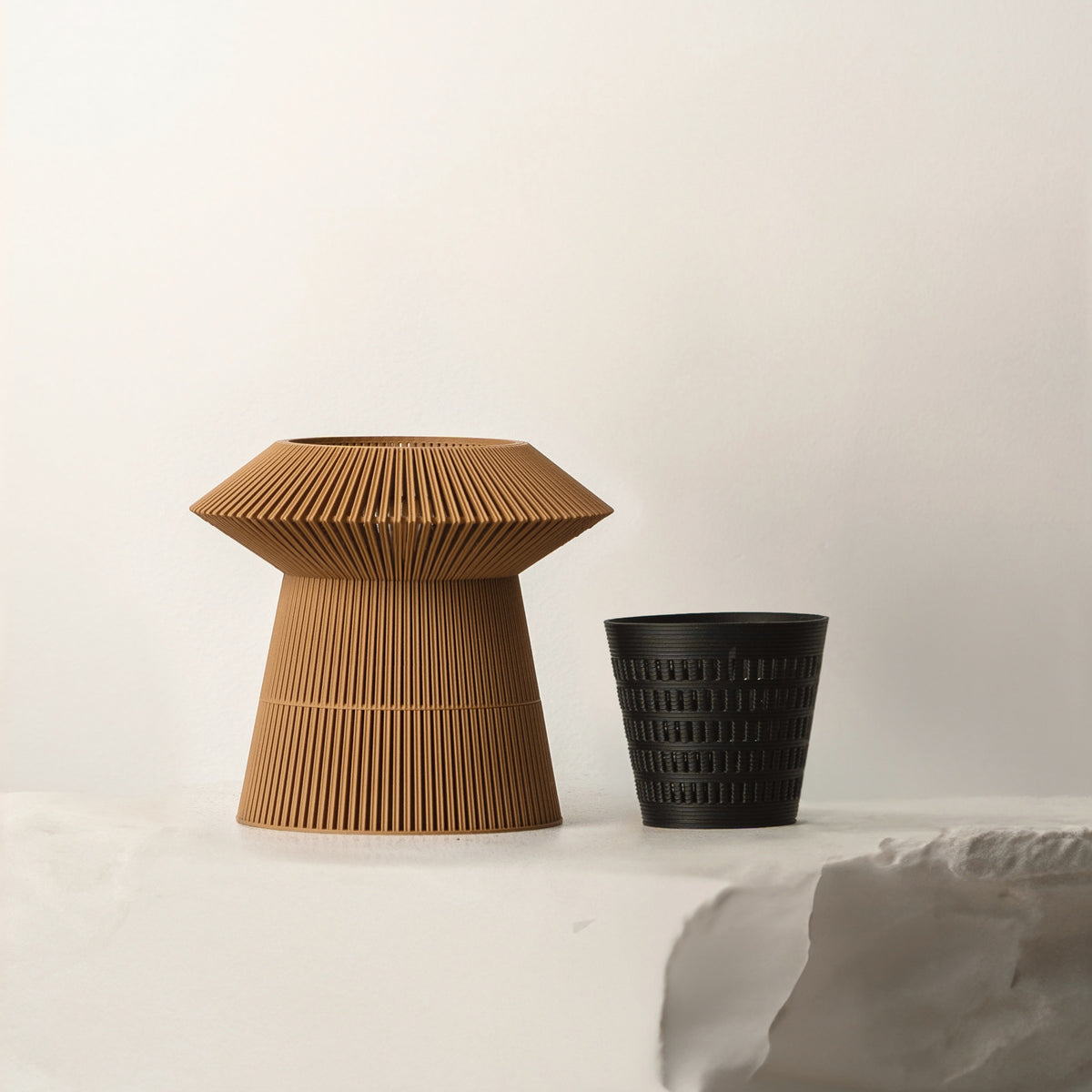 Brown VerdiPot Revolve self-watering planter beside its removable black air-pruning inner pot.