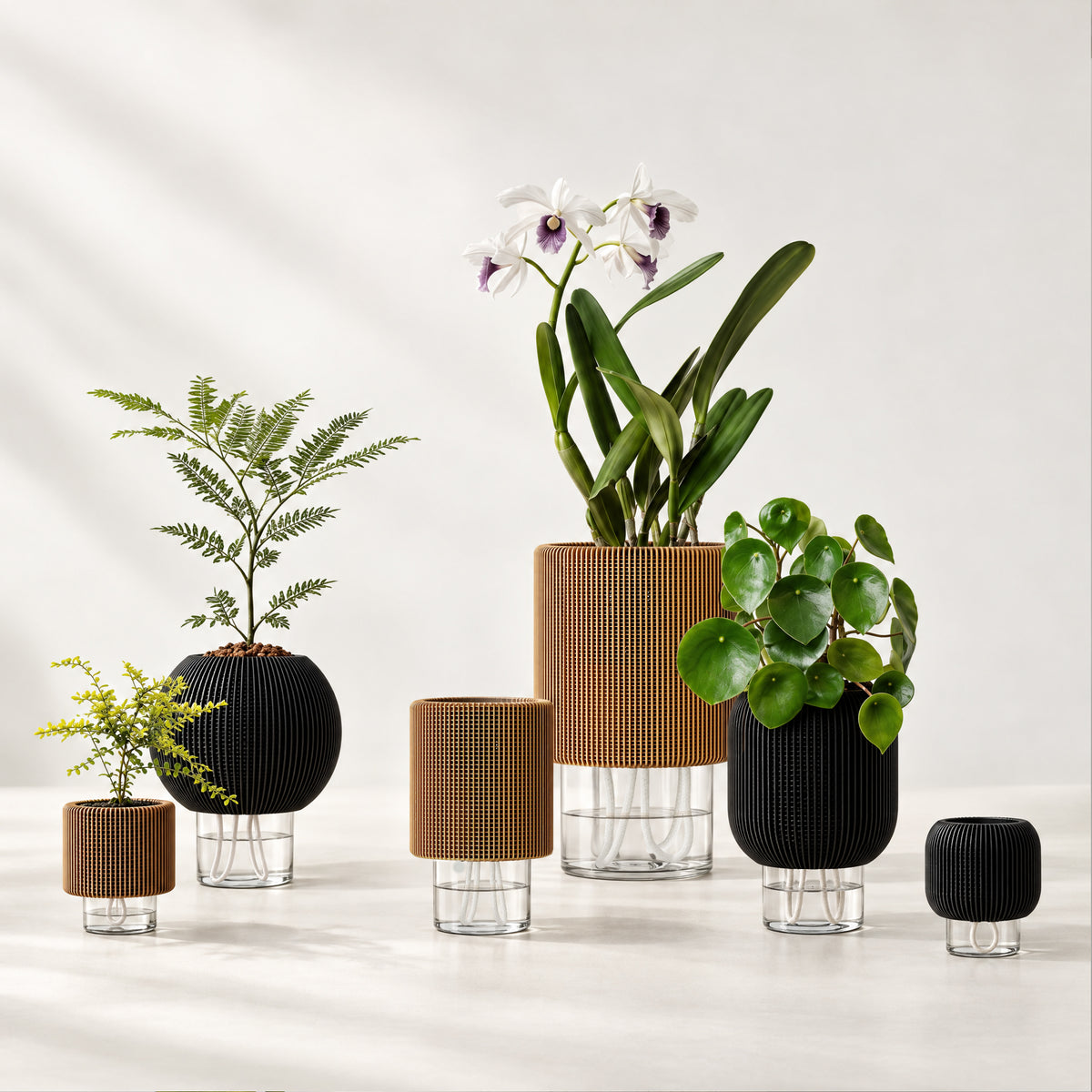 LUXE planters in black and wood tones, with clear glass reservoirs, white wicks and a mix of leafy and flowering plants.